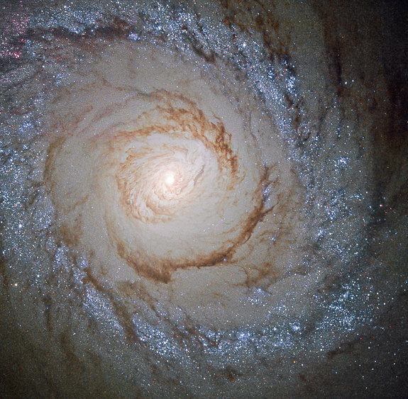 This image shows the galaxy Messier 94, which lies in the small northern constellation of the Hunting Dogs, about 16 million light-years away. Within the bright ring around Messier 94 new stars are forming at a high rate and many young, bright stars are present within it – thanks to this, this feature is called a starburst ring. The cause of this peculiarly shaped star-forming region is likely a pressure wave going outwards from the galactic centre, compressing the gas and dust in the outer region. The compression of material means the gas starts to collapse into denser clouds. Inside these dense clouds, gravity pulls the gas and dust together until temperature and pressure are high enough for stars to be born.